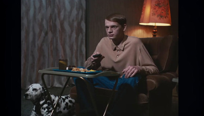 a man sitting in a chair with a tray of food