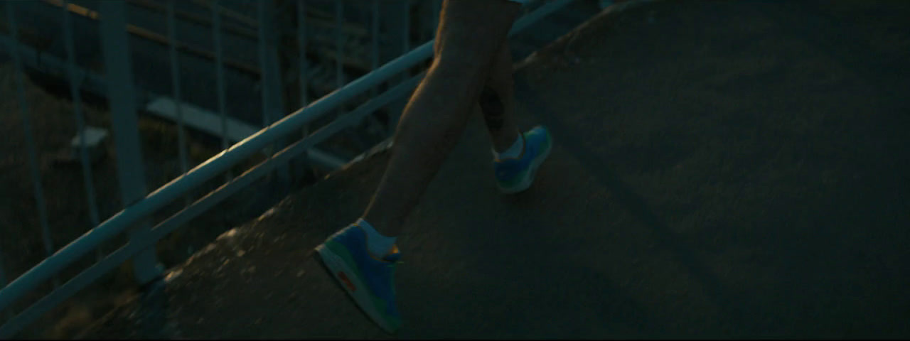 a person with blue shoes walking up a ramp