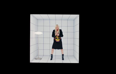 a woman standing in a white tiled room