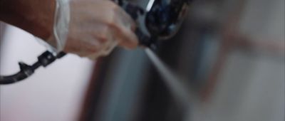 a close up of a person's hand pulling something out of a refrigerator