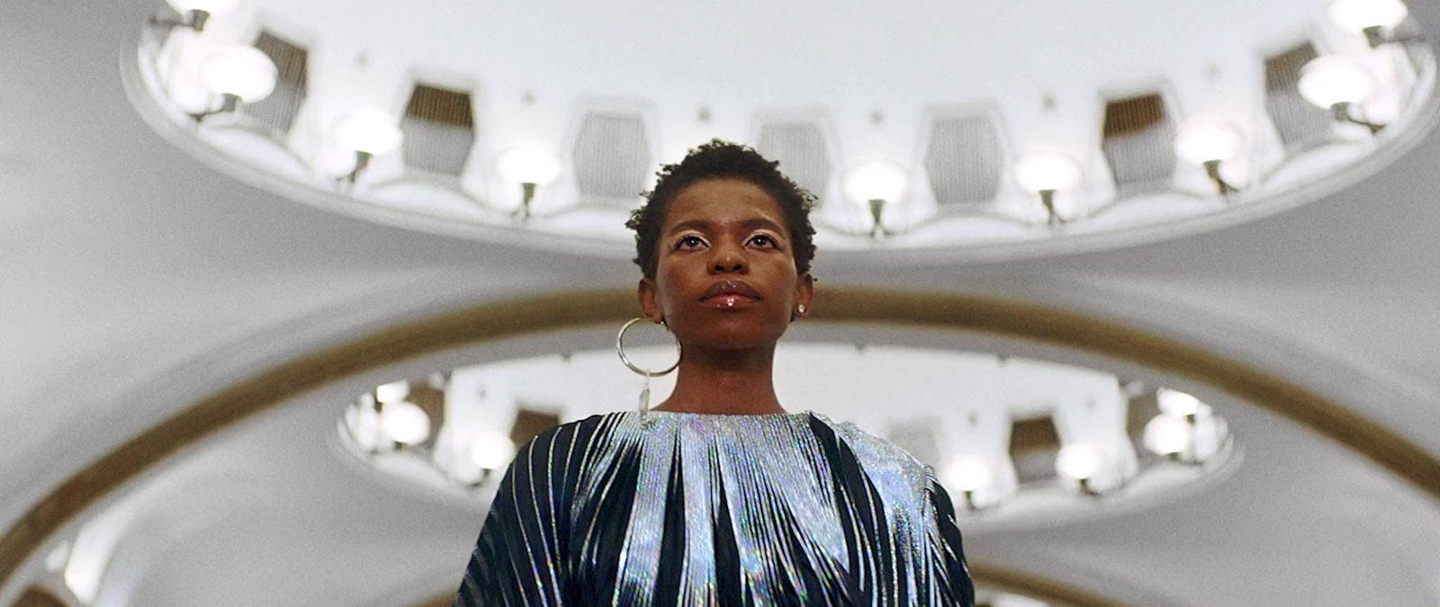 a woman standing in front of a mirror in a room