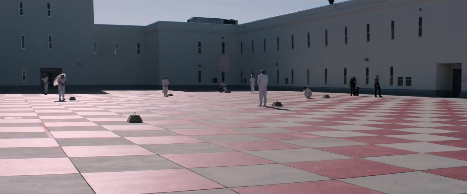 a group of people standing on top of a checkered floor