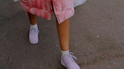 a person walking down a street with a skateboard