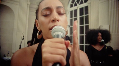 a woman holding a microphone up to her face