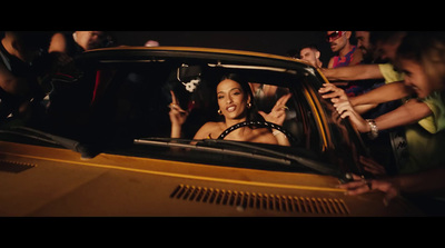 a woman sitting in a car surrounded by people