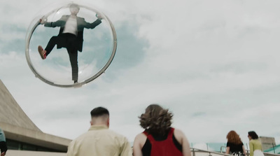 a man in a suit is reflected in a mirror