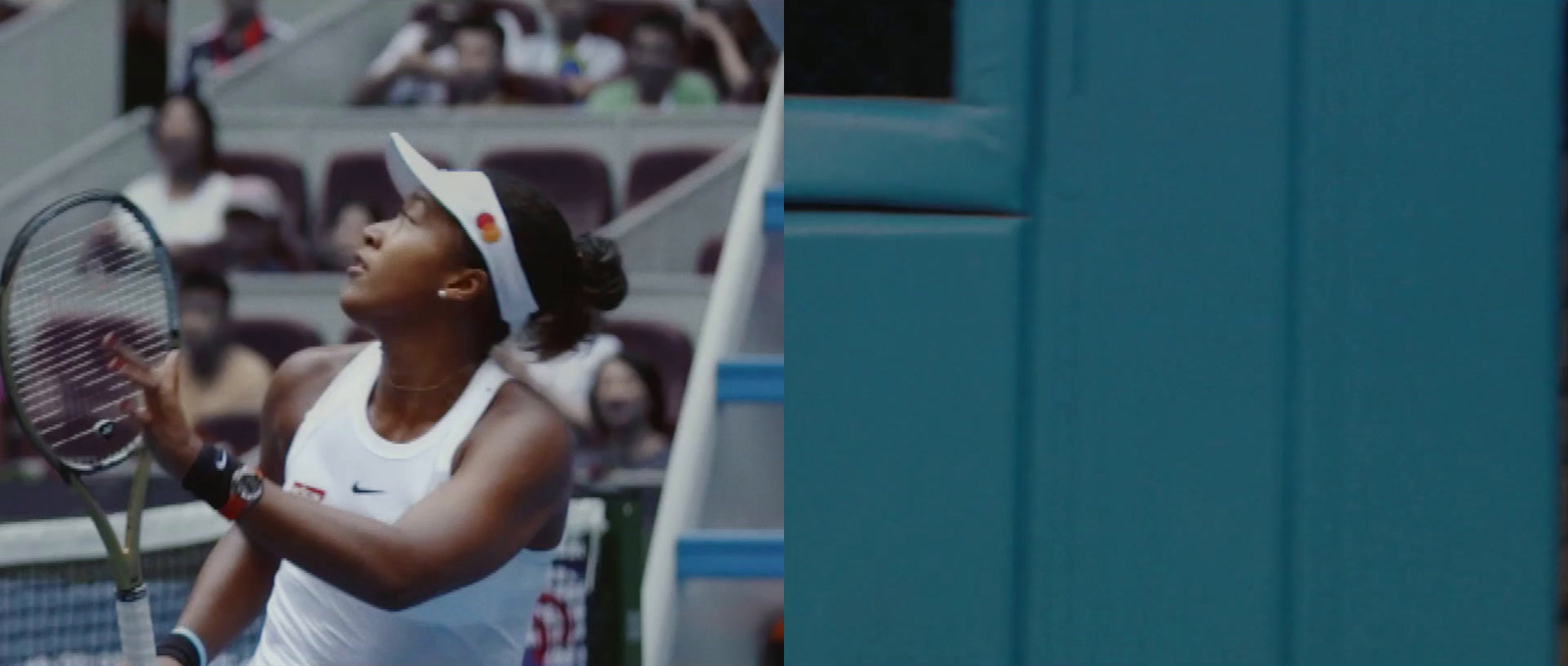 a woman holding a tennis racquet on a tennis court