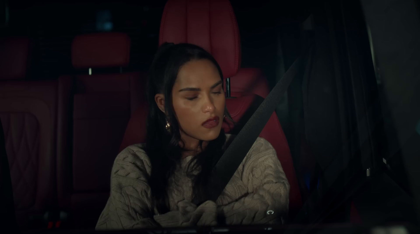 a woman sitting in the back seat of a car