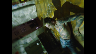 a man with tattoos standing in a room