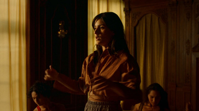 a woman standing in a room with other women