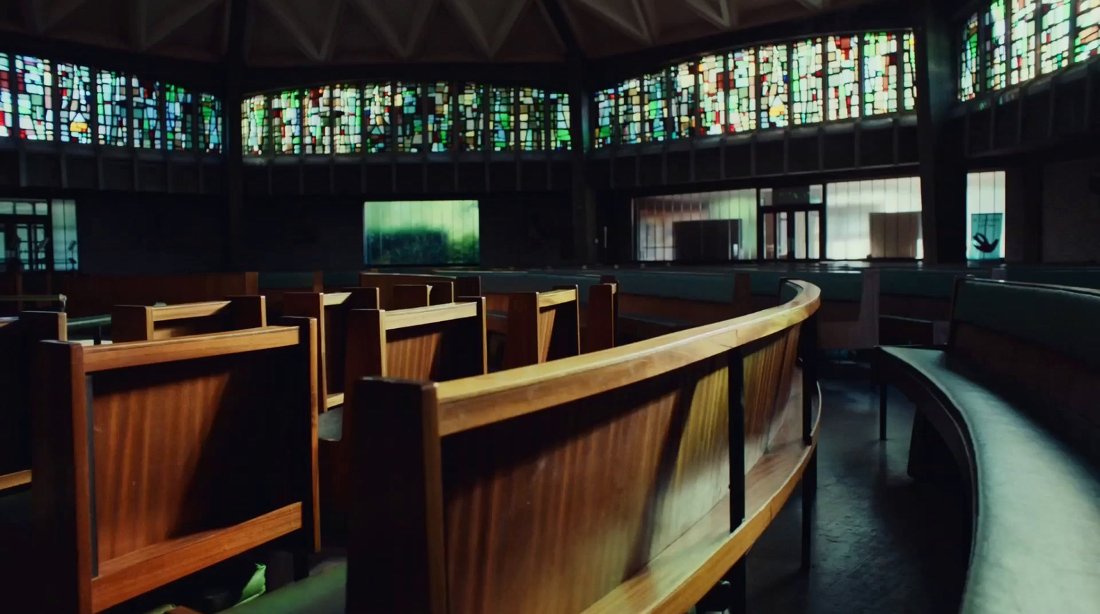 a church with stained glass windows and pews