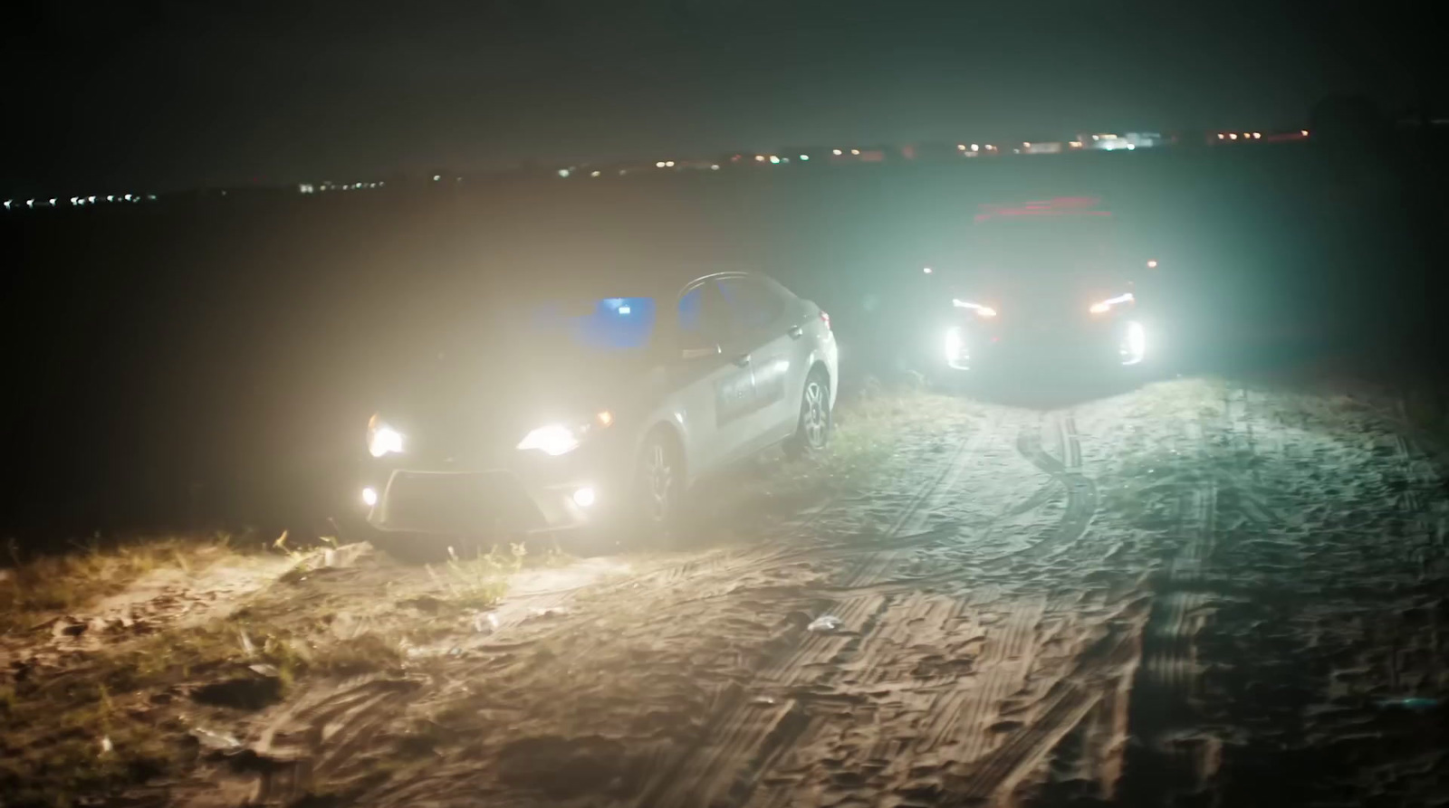 a couple of cars that are sitting in the dirt