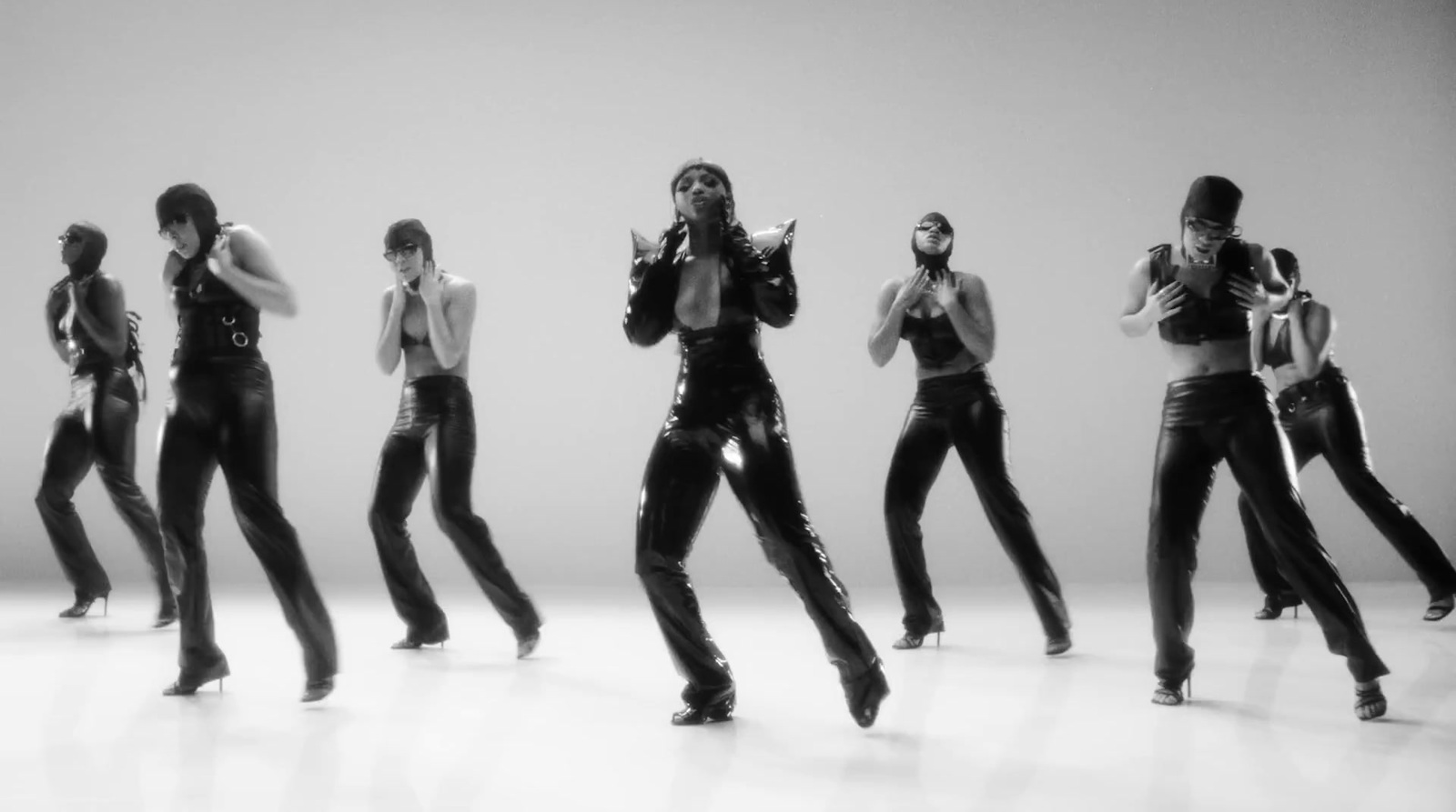 a group of women in black leather outfits