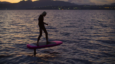 a person standing on a surfboard in the water