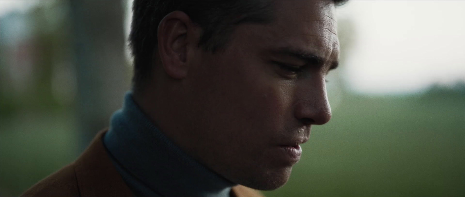 a close up of a person wearing a suit and tie