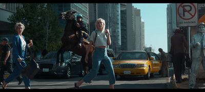 a group of people walking down a street next to a horse