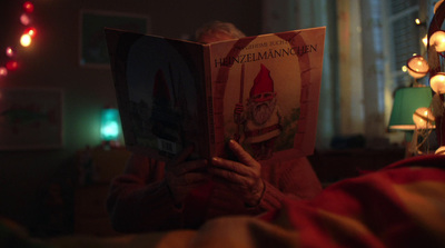 a person reading a book in a dark room