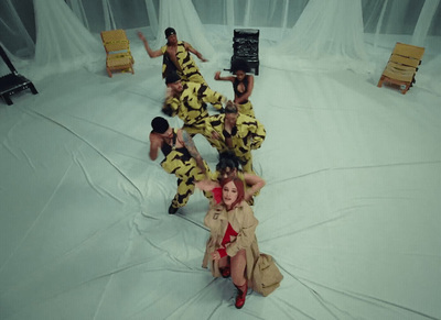 a group of people sitting on top of a white floor