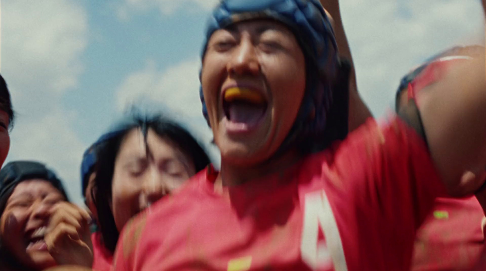 a group of people wearing red shirts and helmets