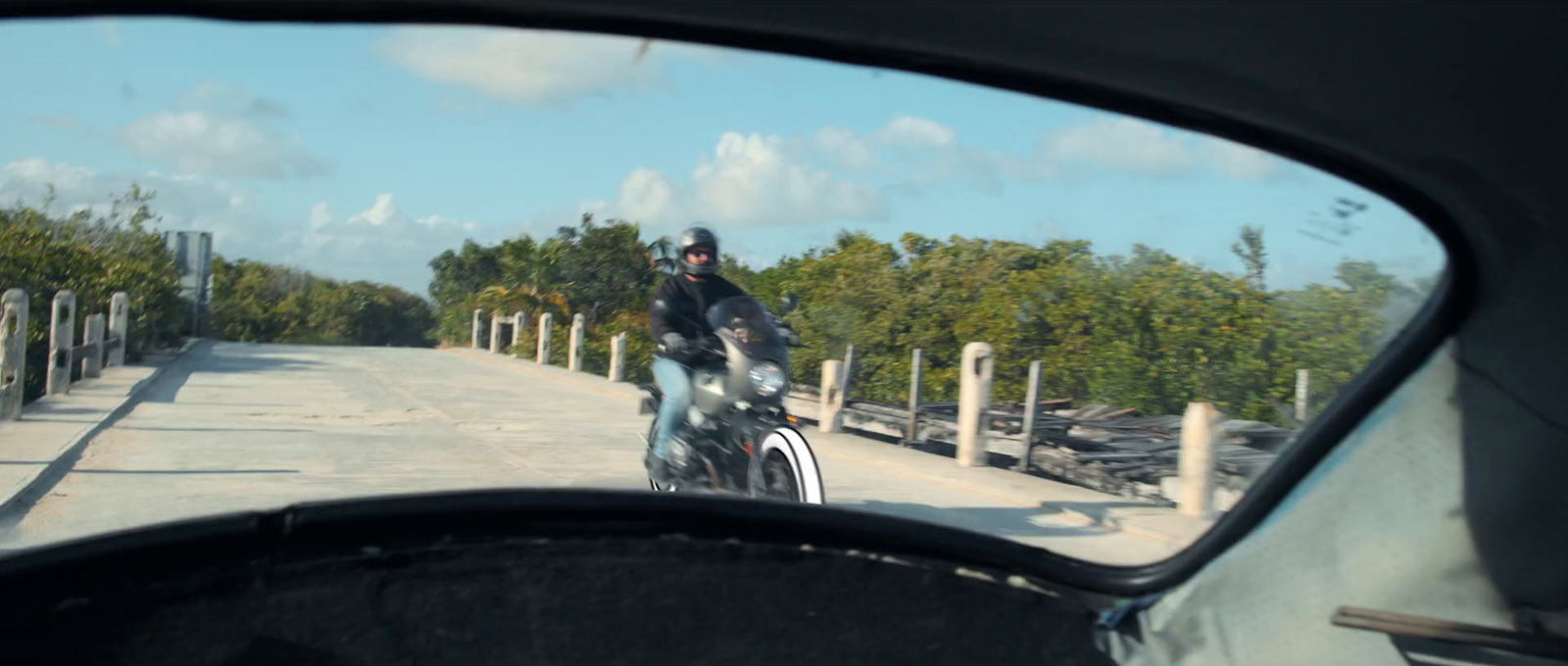 a man riding a motorcycle down a road