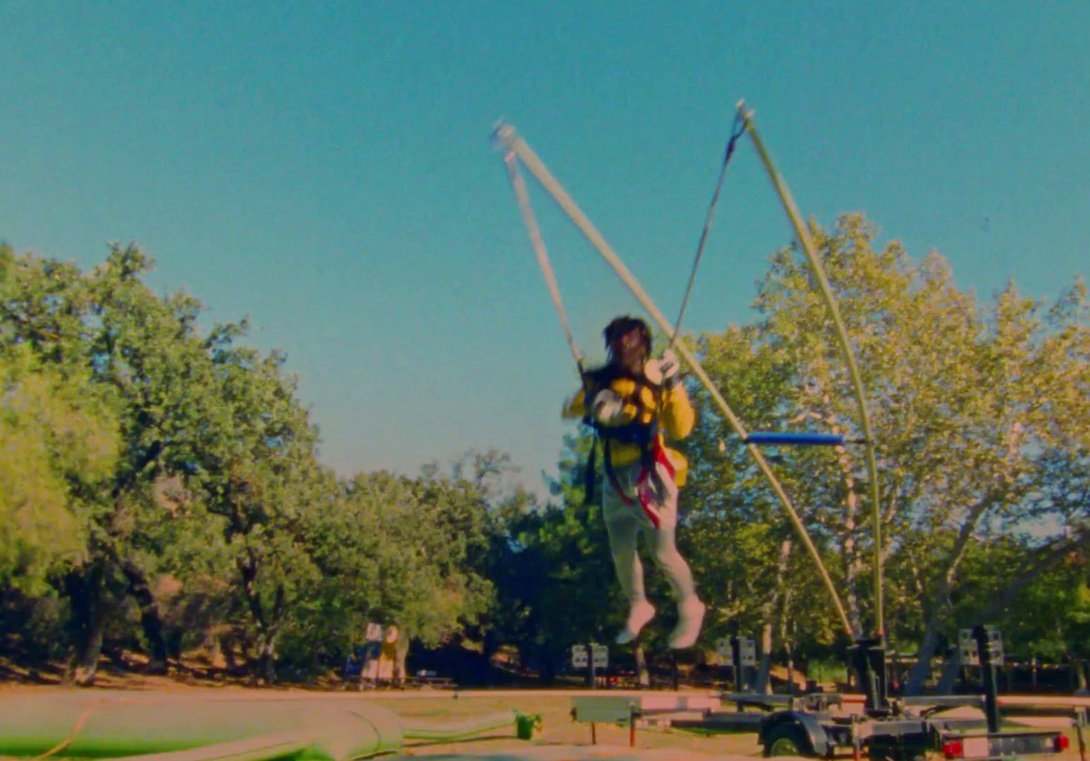 a man is doing a trick on a trampoline