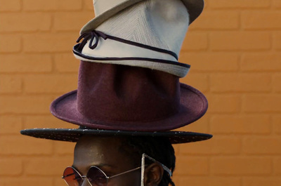 a woman with a hat and sunglasses on her head