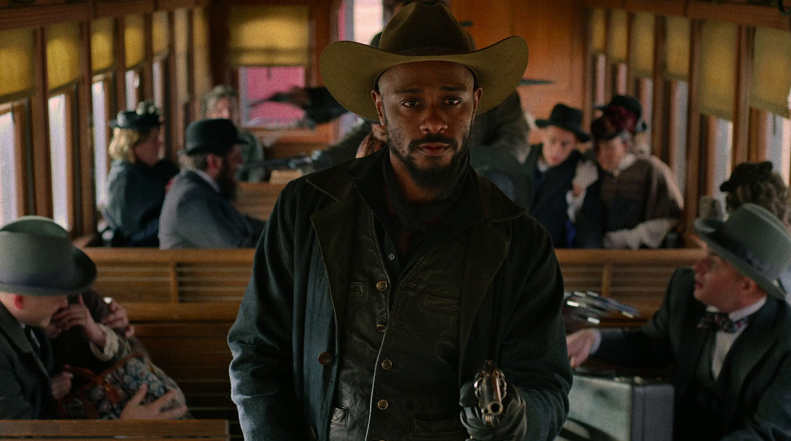 a man in a cowboy hat standing in a train