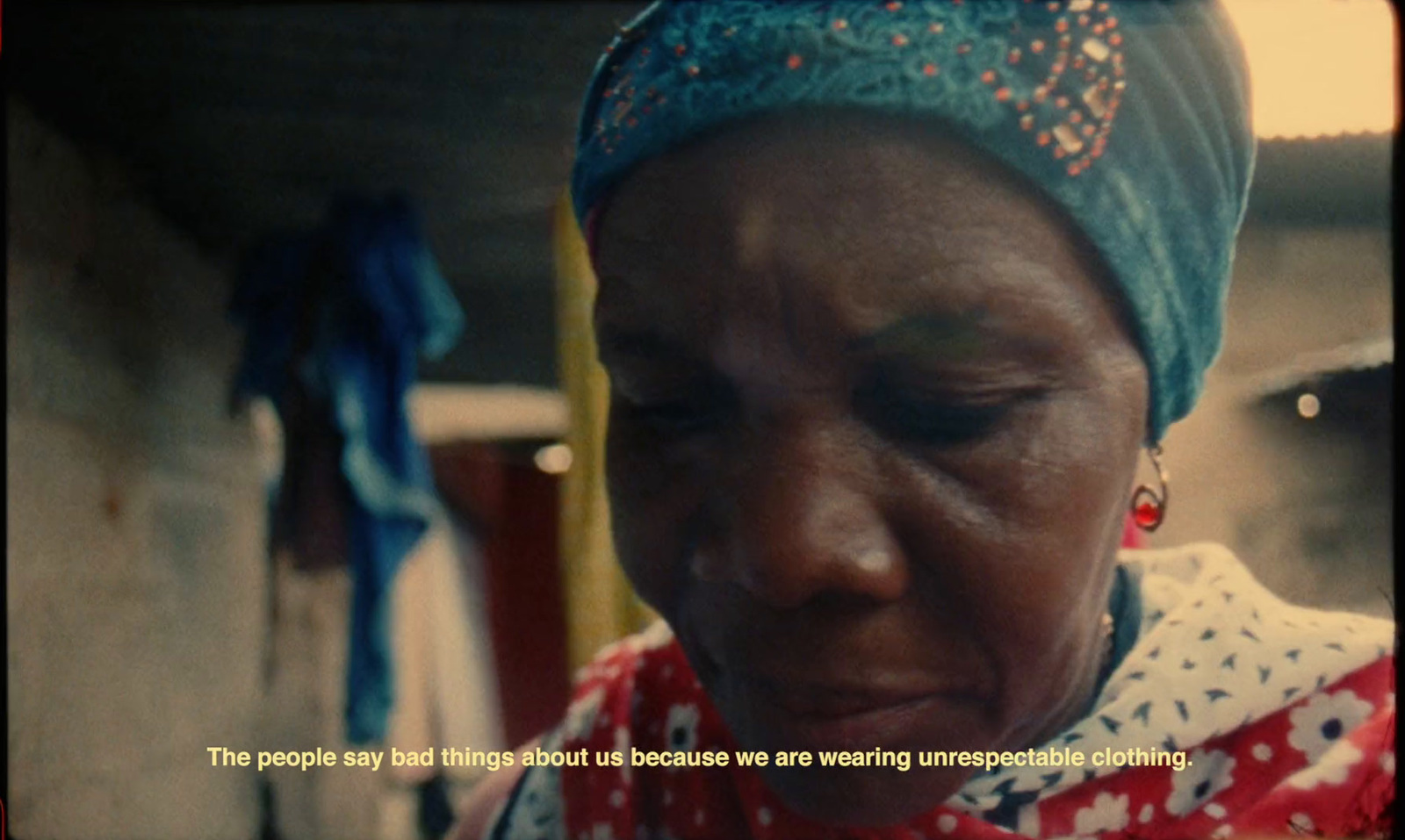 a woman with a red and white shirt and a blue head scarf