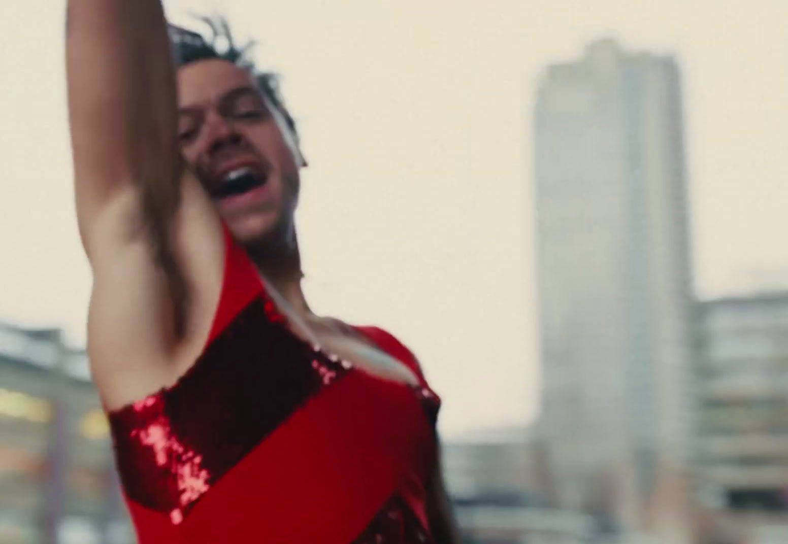 a man in a red and black dress holding a white frisbee