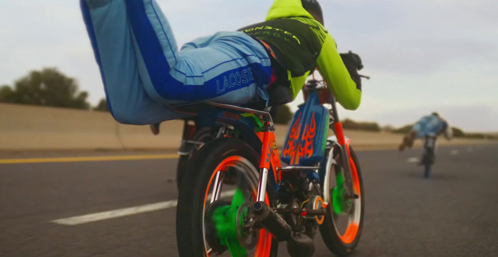 a person riding a bike down a street