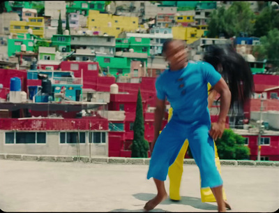 a man in a blue jumpsuit is playing with a frisbee