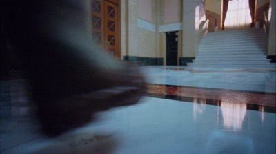 a blurry photo of a person walking down a hall