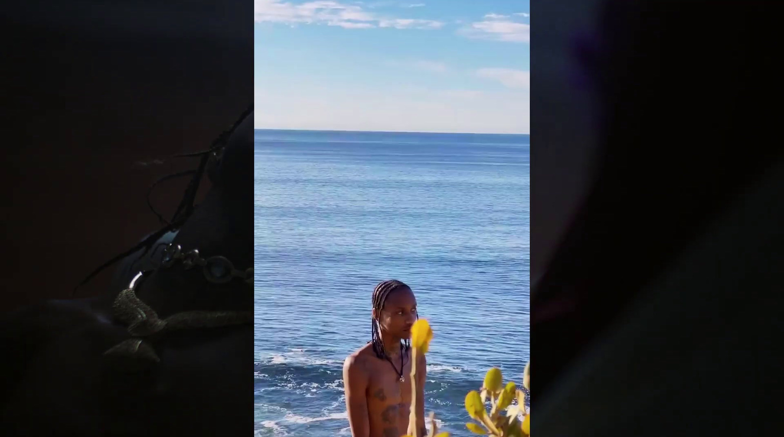 a woman standing on a beach next to the ocean