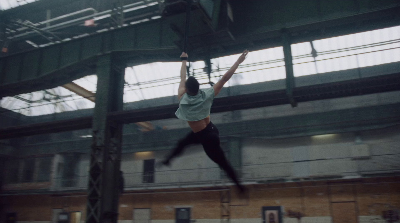 a woman hanging upside down in a building