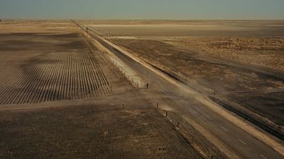 a dirt road in the middle of a desert