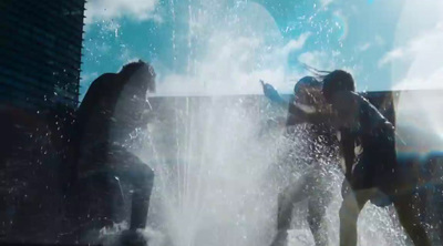 a group of people standing around a fountain