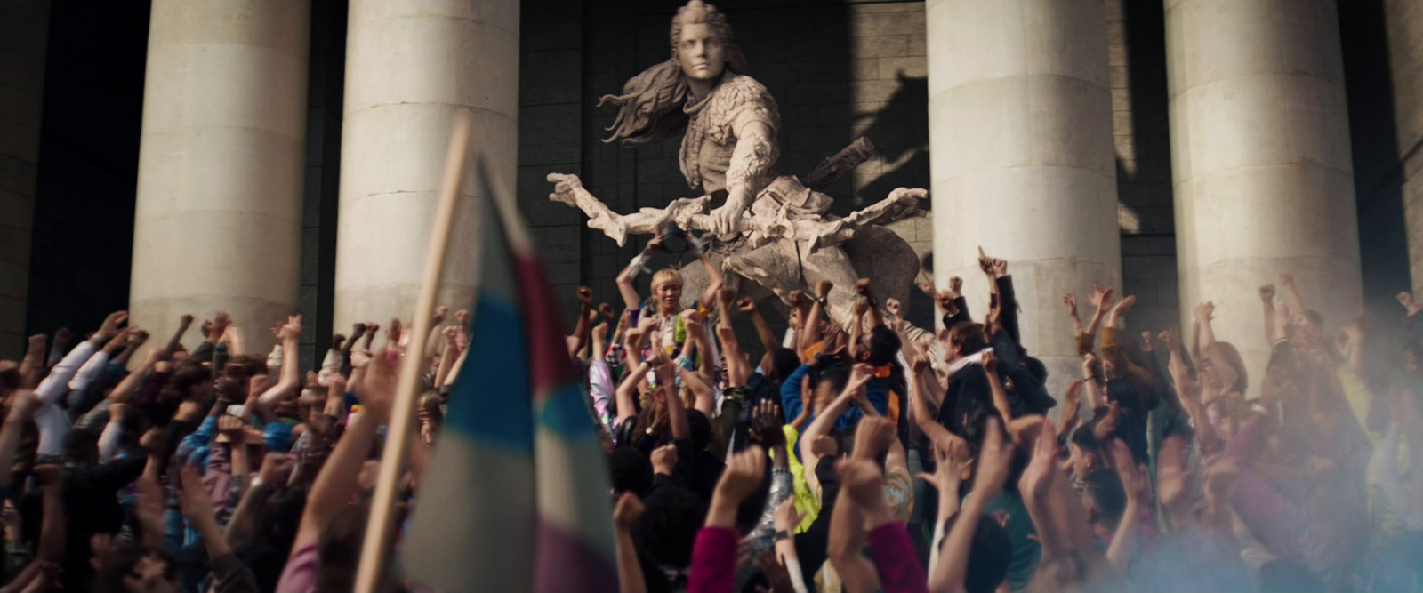 a crowd of people standing around a statue