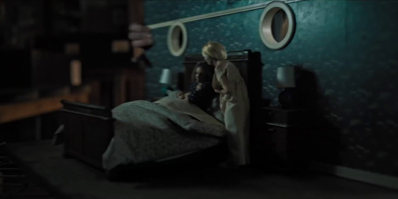 a doll sitting on top of a bed in a room