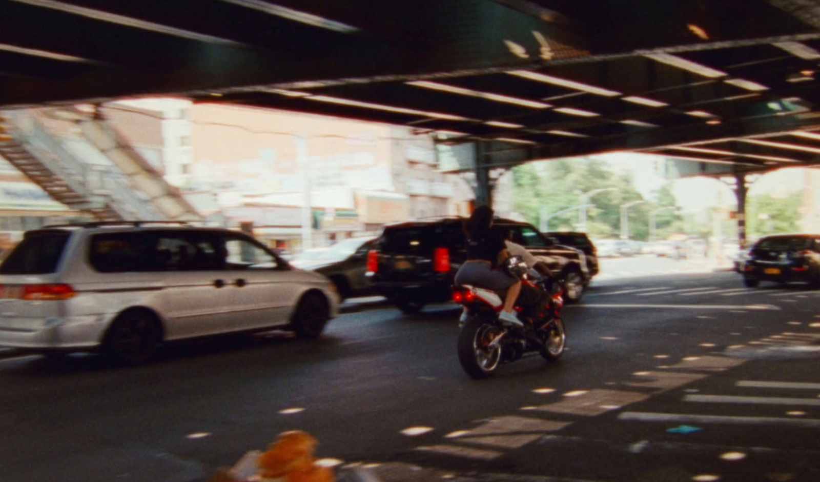 a motorcyclist rides down a busy city street