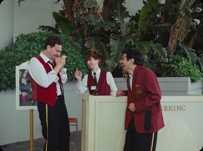 a group of men standing next to each other in front of a counter