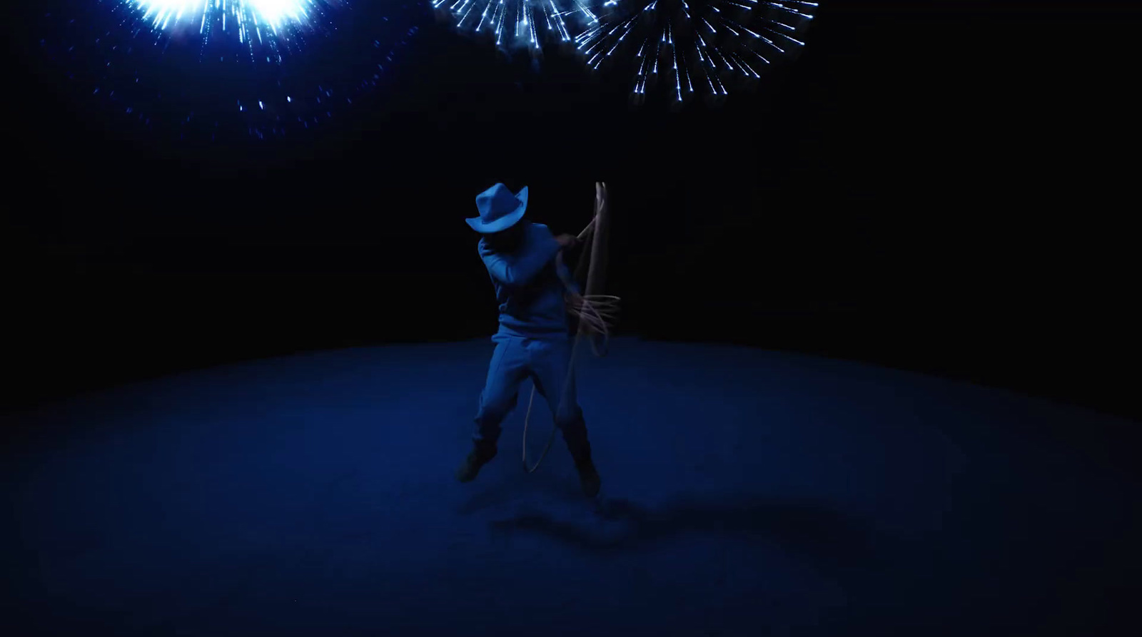 a man in a cowboy hat holding a baseball bat