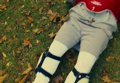 a person laying on top of a grass covered field