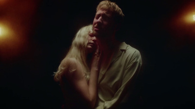 a man standing next to a woman in a dark room