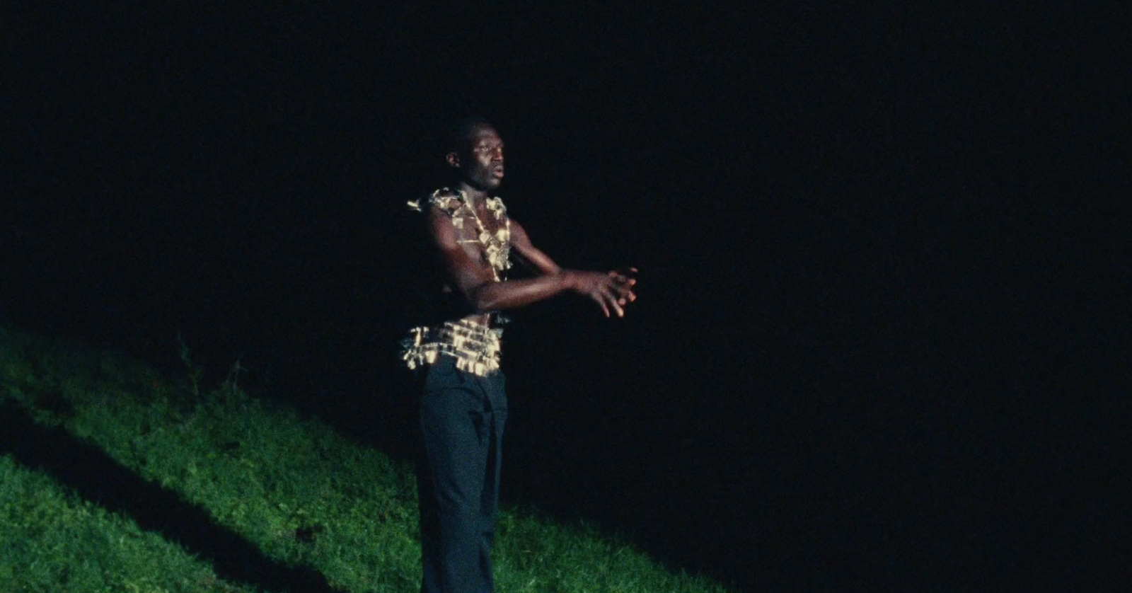 a man standing on a hill in the dark