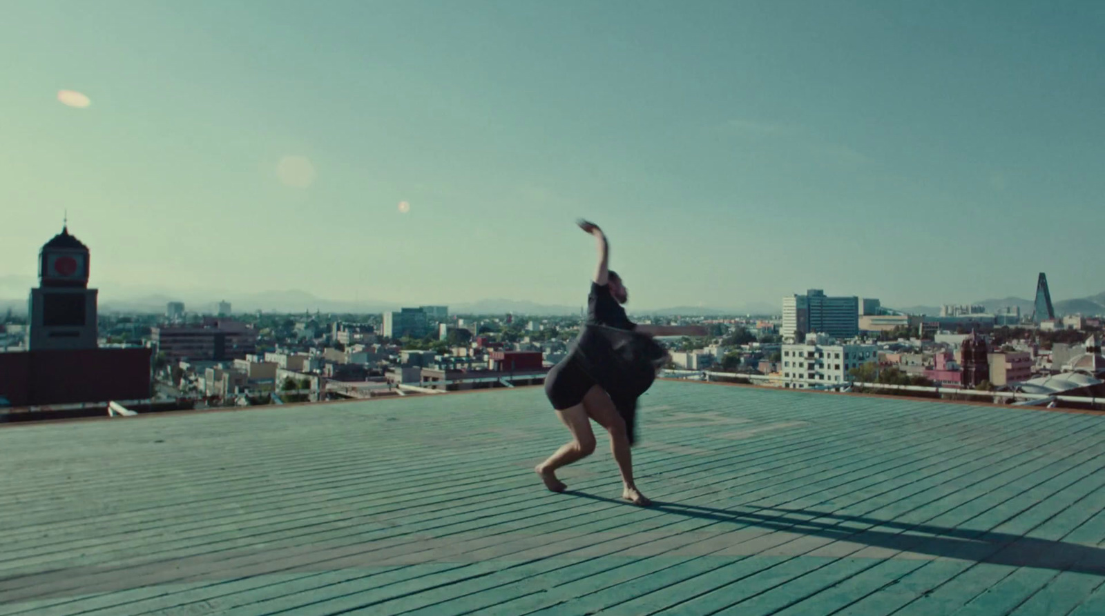 a person doing a handstand on a wooden deck