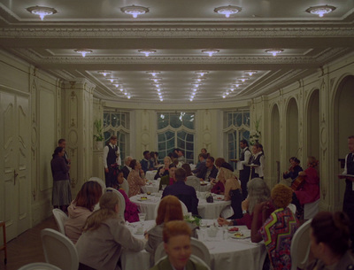 a group of people sitting at tables in a room