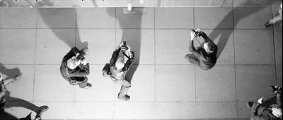 a group of people standing on top of a tiled floor