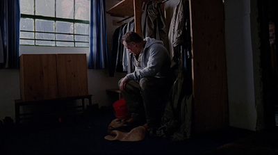 a man sitting on a stool in a room