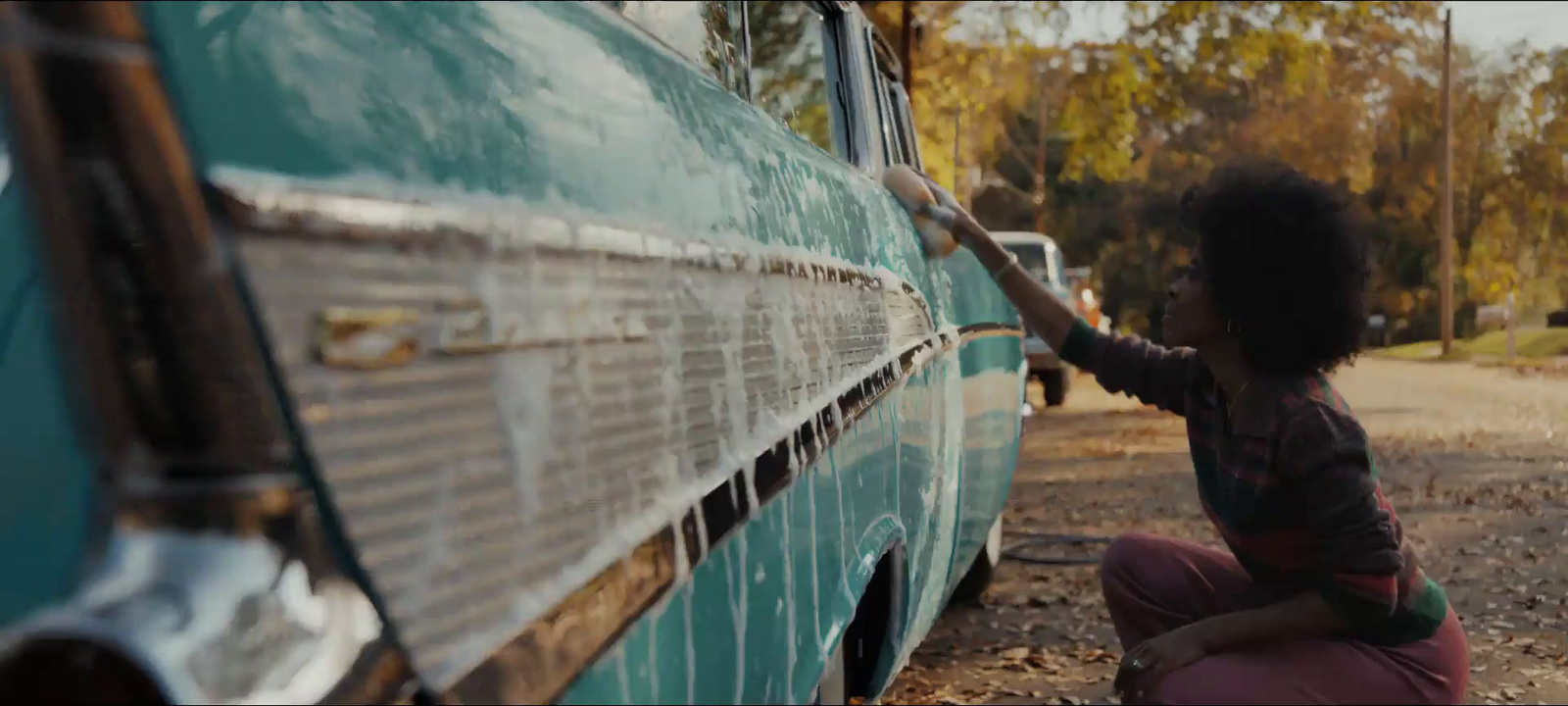 a little girl is writing on the side of a bus