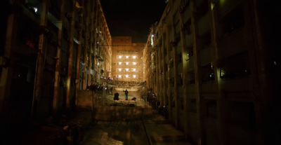 a dark alley way with people walking down it at night